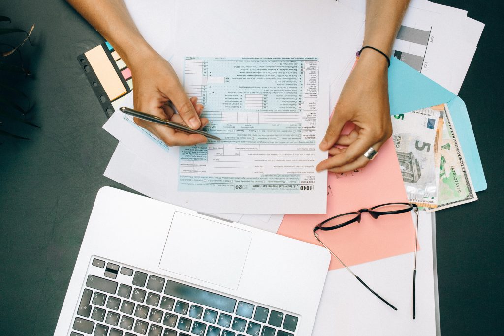 Person looking through spread sheets to manage debt