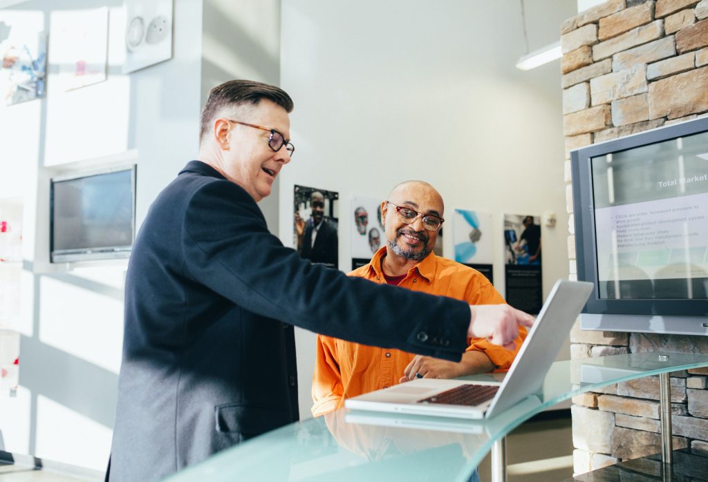 Two men using computer for education