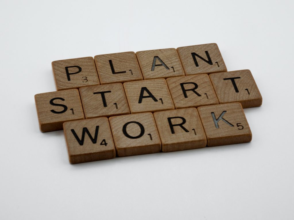 Scrabble letters spelling out the words "Plan, start, work"