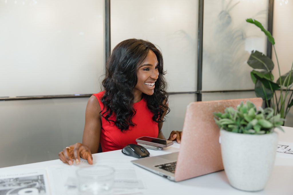 Smiling business owner working on her laptop